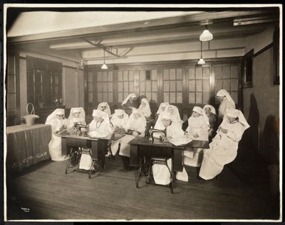 Women wearing white smocks, in a sewing class, presumably during or associated with World War I, New York by Byron Company